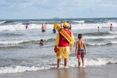 Foto de salva-vidas observando banhistas na praia