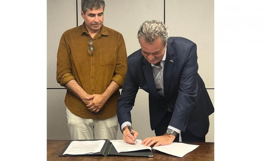 Diretor-presidente do IAT assinando documento