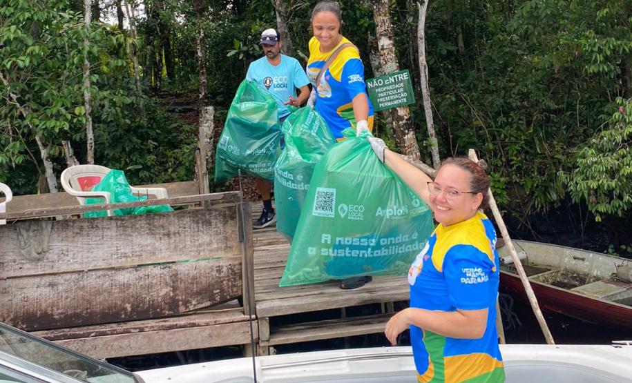Voluntários coletando resíduos e posando para a foto
