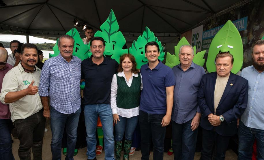 Foto de autoridades e crianças durante soltura de peixes